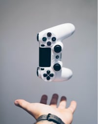 image of hand catching gaming console joypad